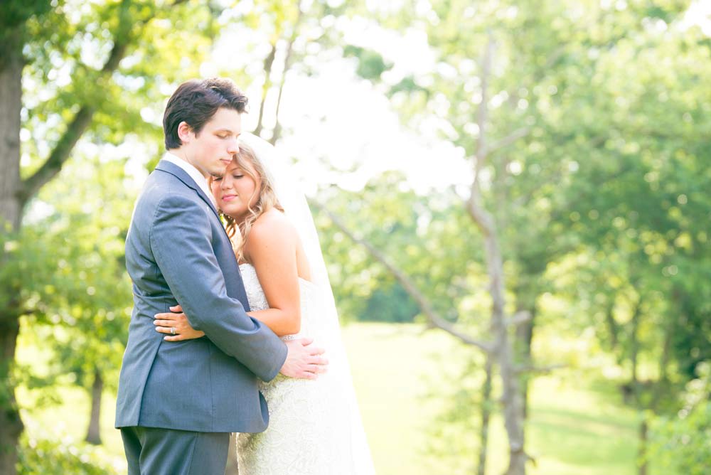 bride and groom outdoors hugging